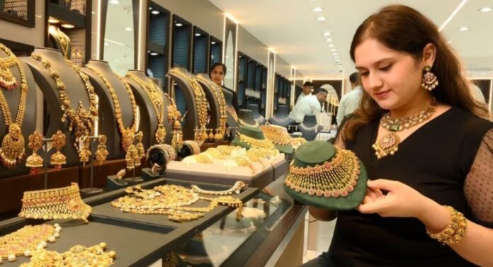 Woman examining gold jewelry in a store.